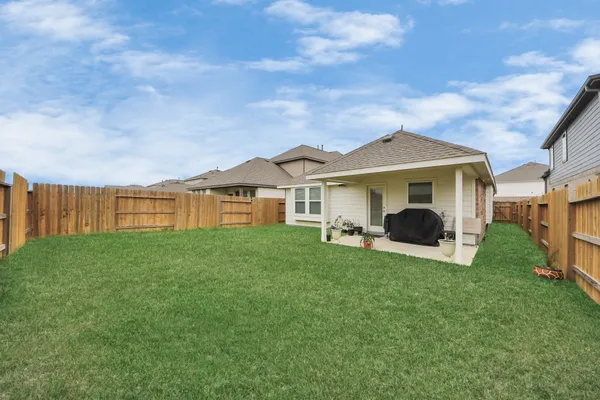 a view of a house with backyard and porch