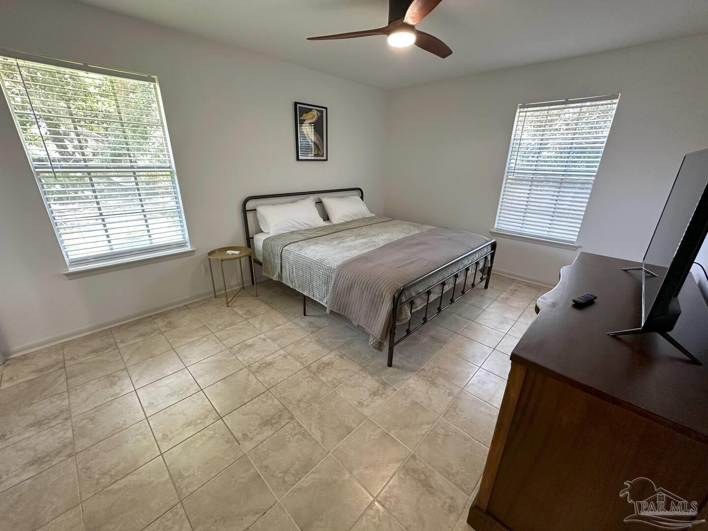 1406 Rancho Villa Drive Gulf Breeze, FL 32563 - Photo 12 of 19 a spacious bedroom with a bed and a window