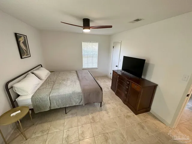 a bedroom with a bed and a television