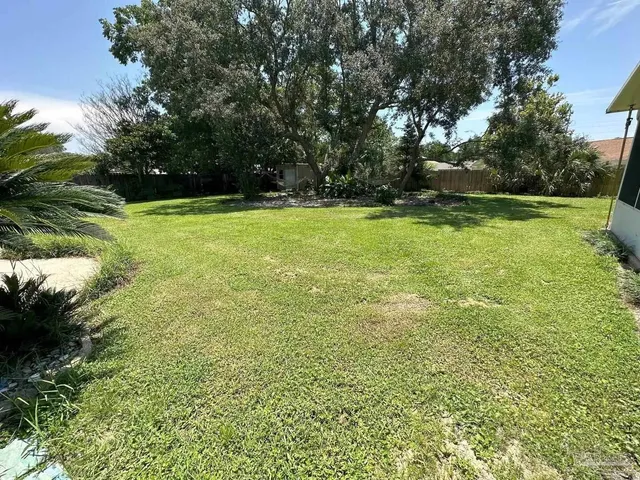 a view of outdoor space with deck and yard
