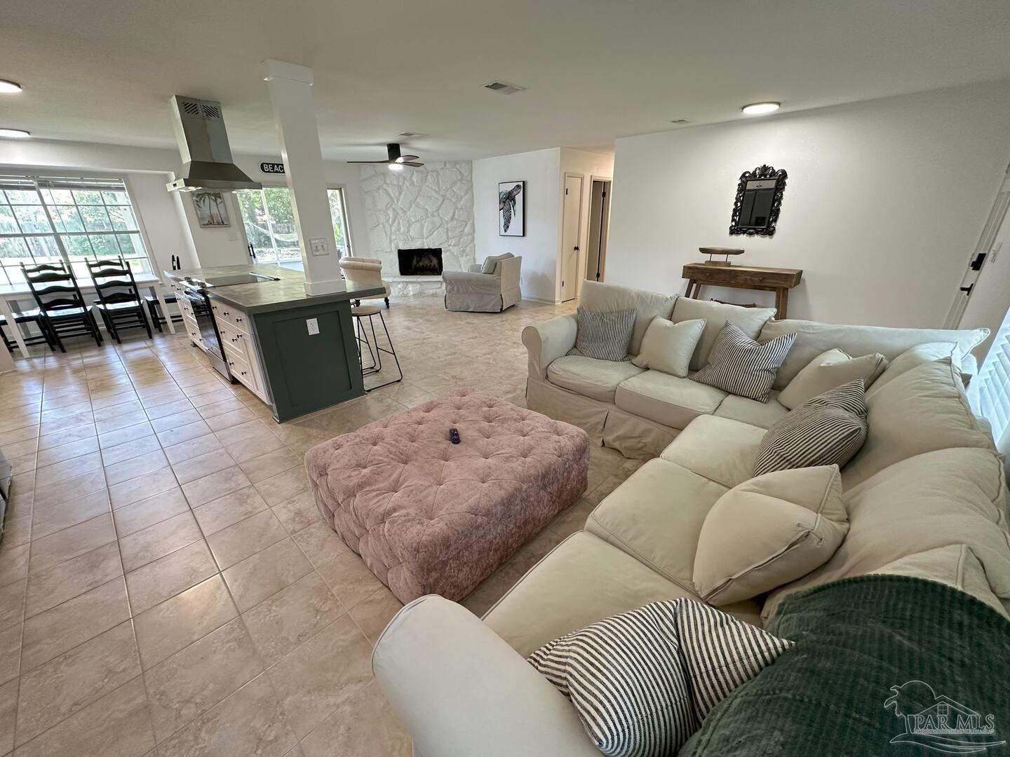 1406 Rancho Villa Drive Gulf Breeze, FL 32563 - Photo 2 of 19 a living room with furniture and a wooden floor