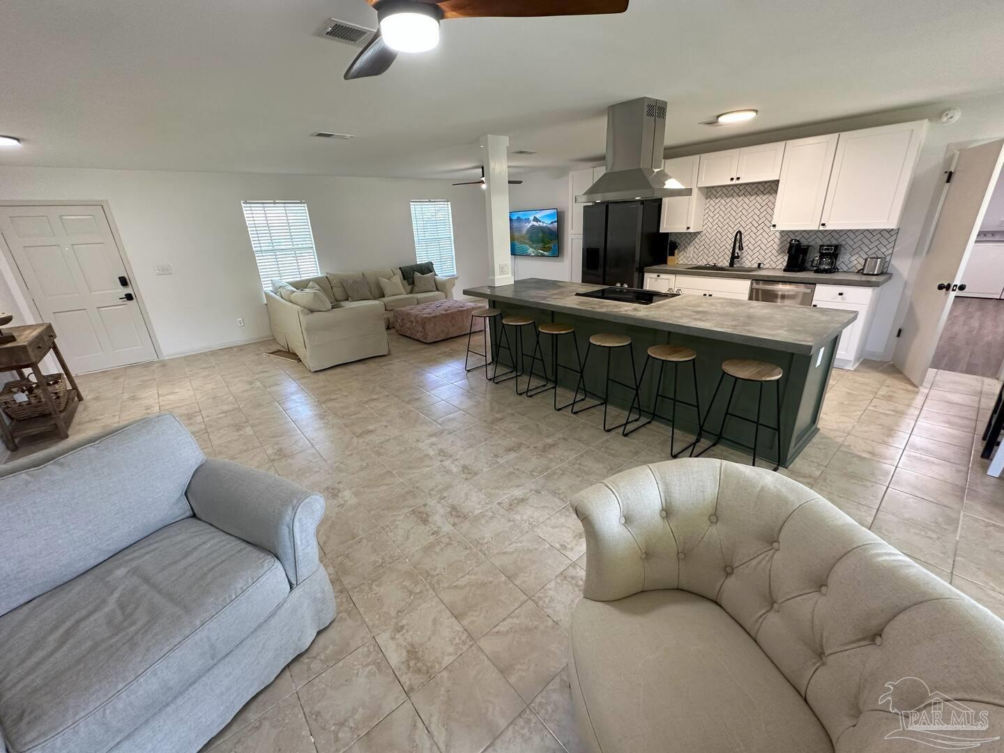 1406 Rancho Villa Drive Gulf Breeze, FL 32563 - Photo 3 of 19 a living room with furniture and kitchen view