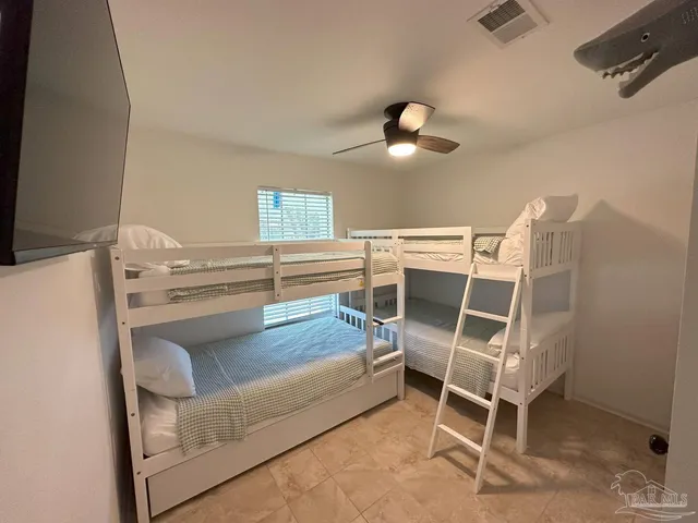 a bedroom with a bed and a chair