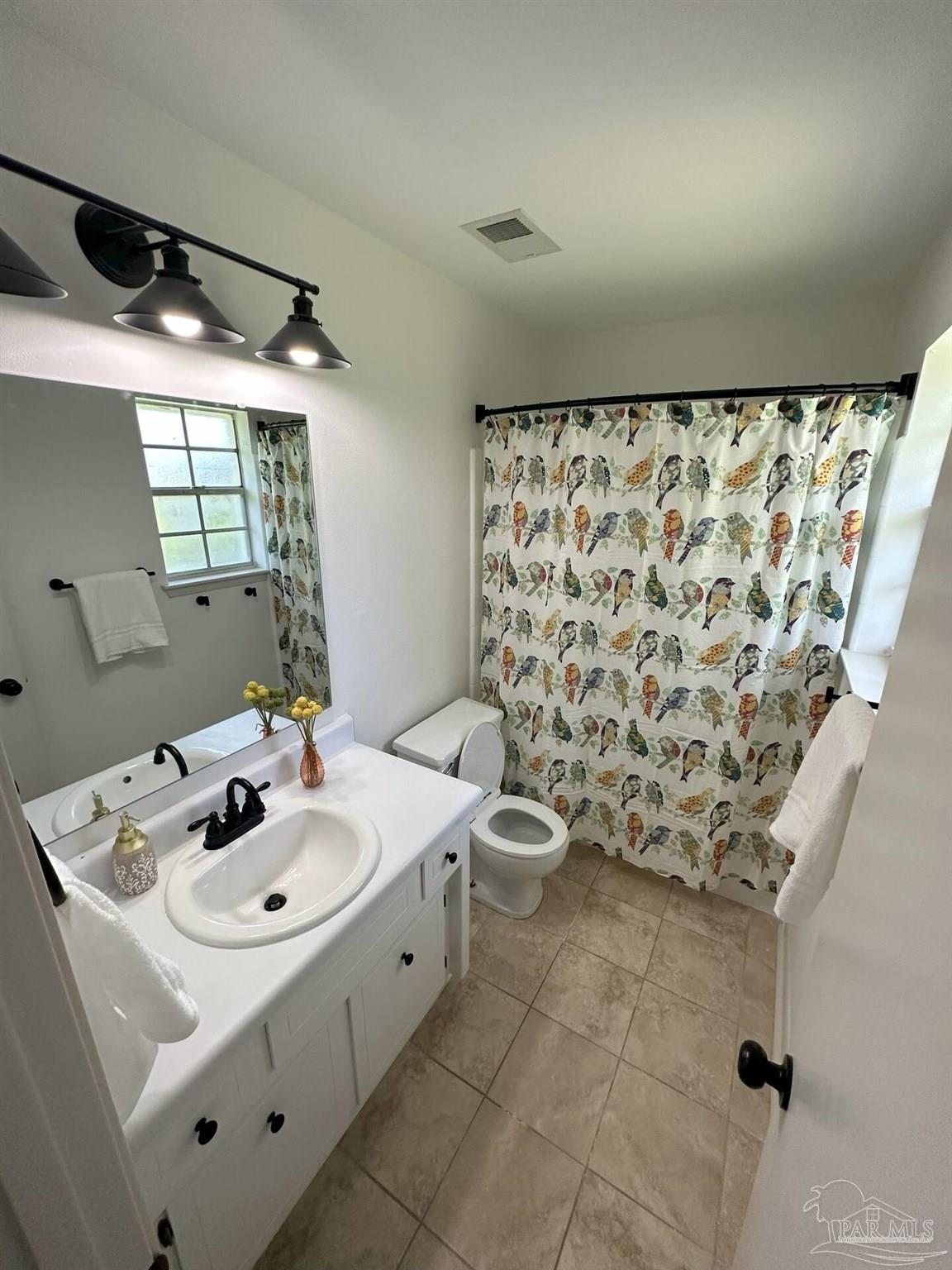 1406 Rancho Villa Drive Gulf Breeze, FL 32563 - Photo 8 of 19 a bathroom with a sink and a mirror