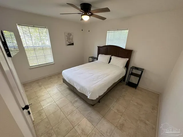 a bedroom with a bed and a window