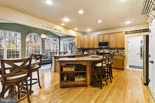 a view of a dining room with furniture and a fireplace