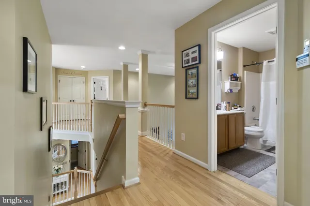 a view of a kitchen with refrigerator and wooden floor