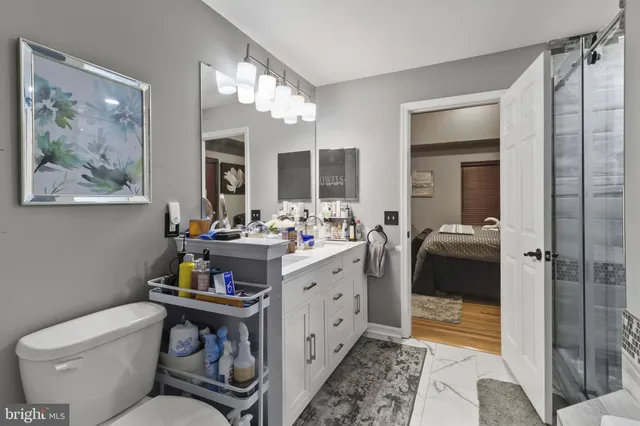 a bathroom with a toilet sink and mirror
