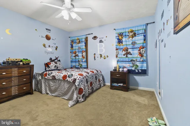 a bedroom with a bed and a book shelf