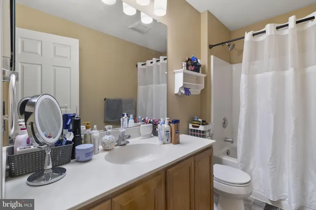 a bathroom with a toilet a sink and a mirror