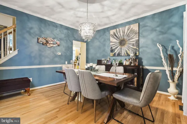 a view of a dining room with furniture wooden floor and chandelier