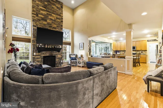 a living room with fireplace furniture and a flat screen tv