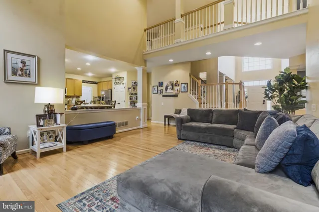 a living room with furniture and kitchen view