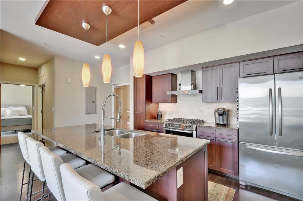 1600 Barton Springs Road, Unit 6602 Austin, TX 78704 - Photo 11 of 39 The island seating serves the perfect built-in dining space and is the gathering hub for exciting conversations.