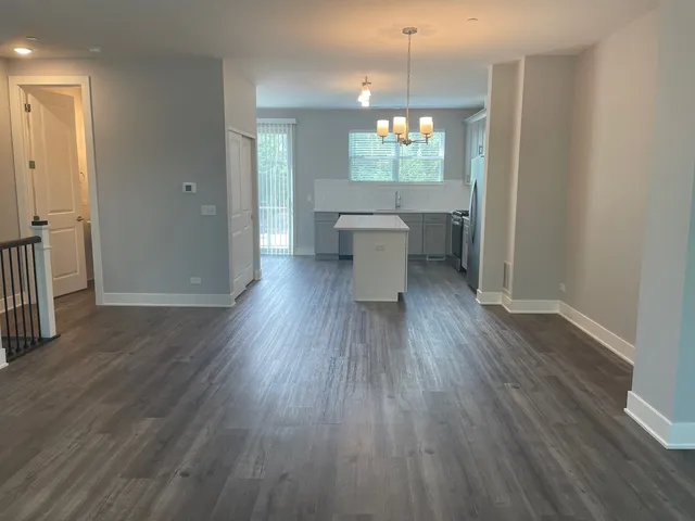 a view of a kitchen from the hallway with a window