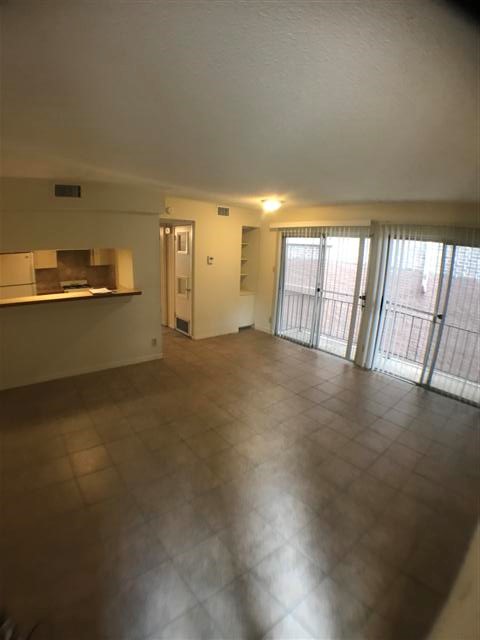 2610 Salado Street, Unit 105 Austin, TX 78705 - Photo 2 of 11 a view of an empty room and window