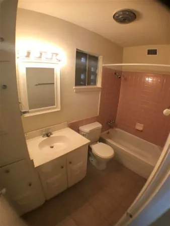a bathroom with a toilet and a bathtub