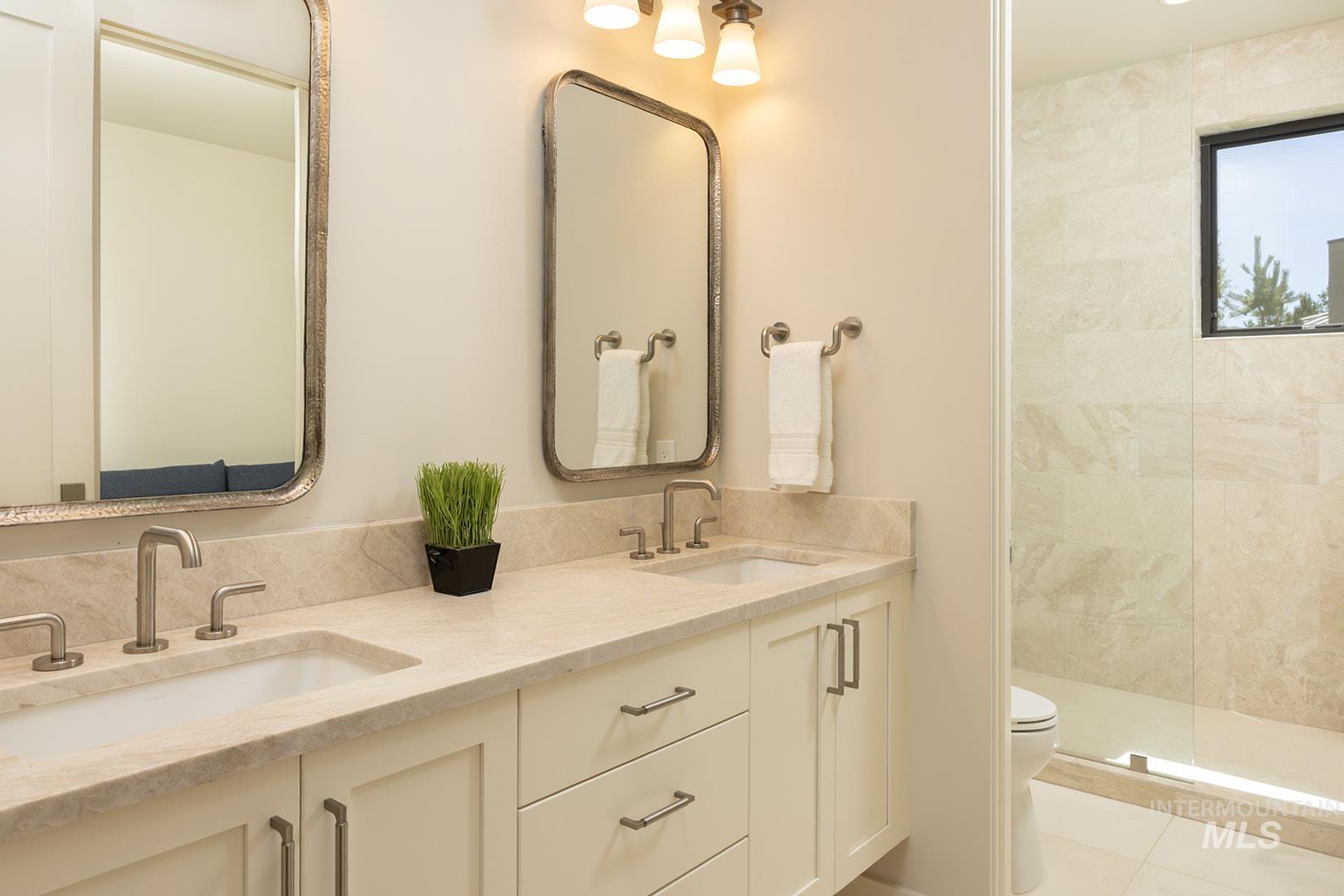 27 Streamside Drive Hailey, ID 83333 - Photo 22 of 39 Full bathroom featuring double vanity, tiled shower, and tile patterned floors