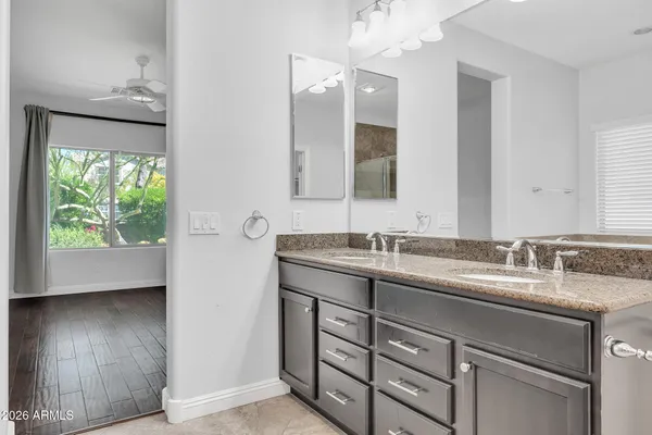 a bathroom with a double vanity sink and a mirror