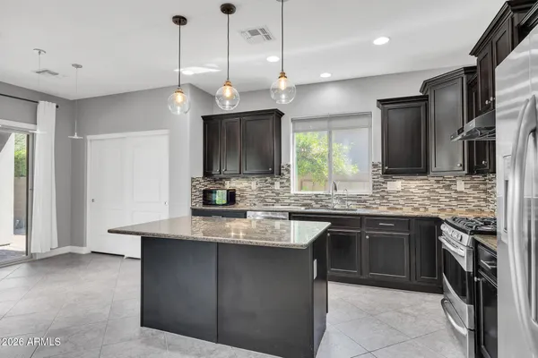 a large kitchen with a sink and stainless steel appliances