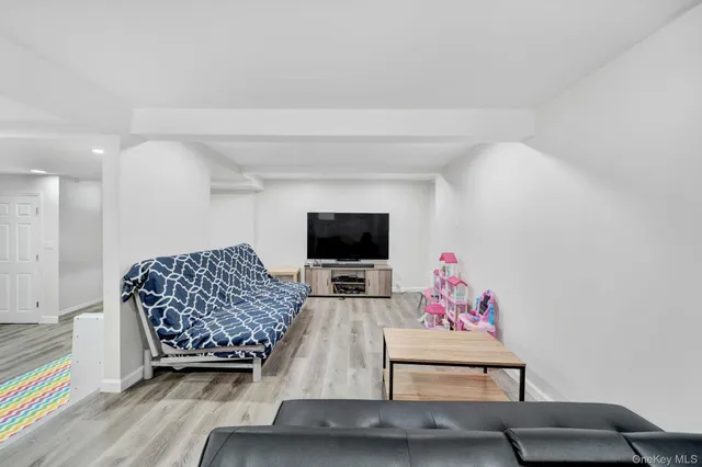 a living room with furniture and flat screen tv