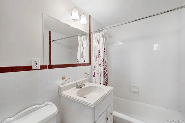 a bathroom with a sink toilet vanity and tub