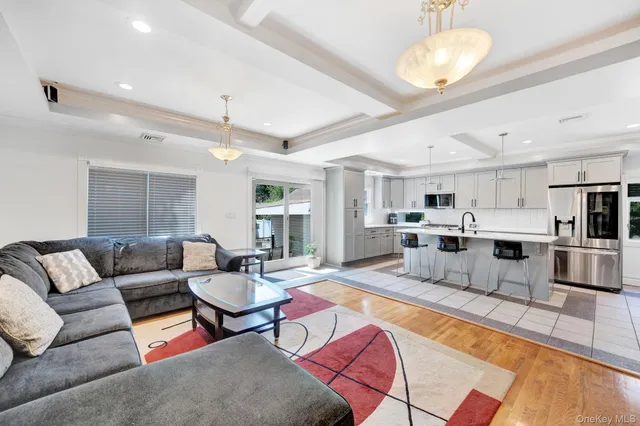 a living room with lots of furniture and kitchen view