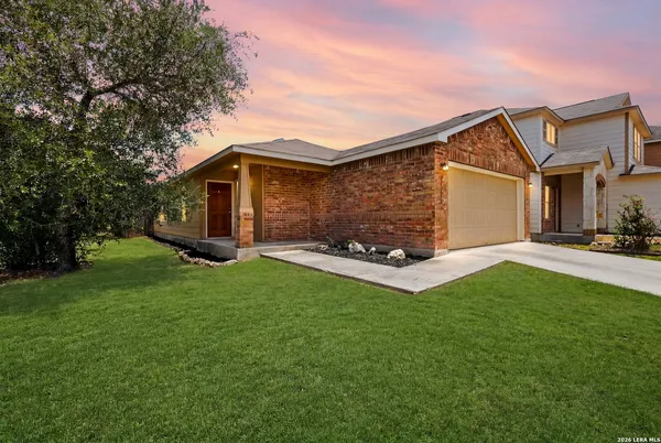 a front view of house with yard and green space