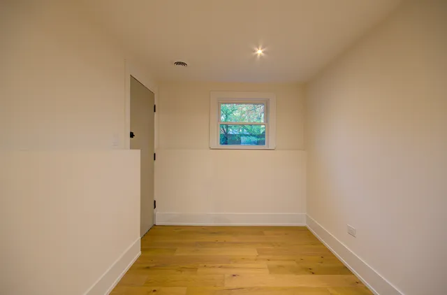 a view of a room with a window and a ceiling fan