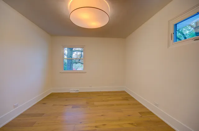 a view of a room with wooden floor and window