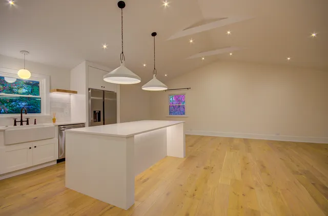 a kitchen with stove and cabinets