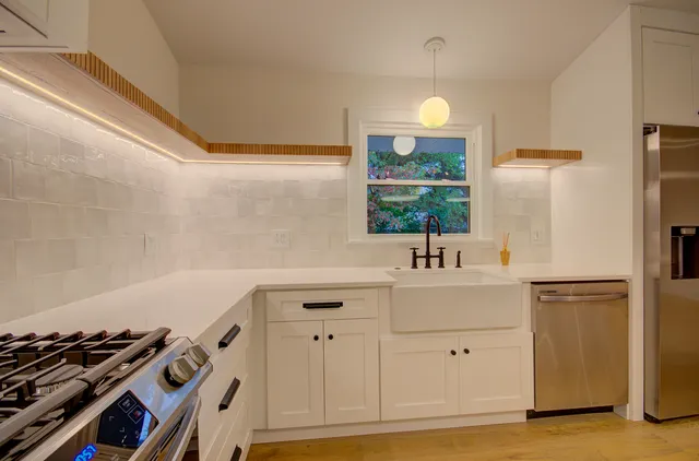 a kitchen with a sink appliances and cabinets