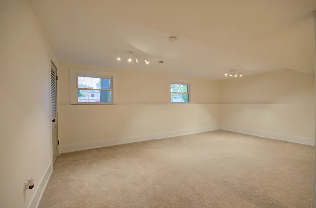 an empty room with a empty space and windows