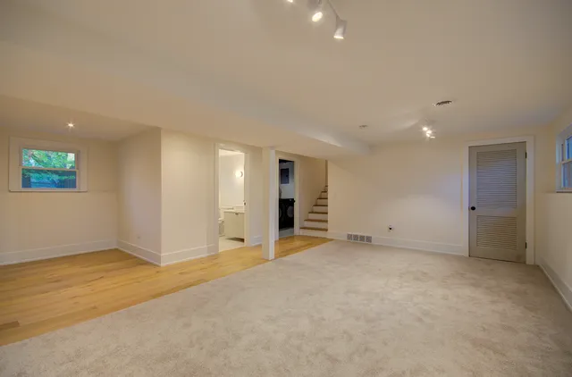 an empty room with a empty space and windows