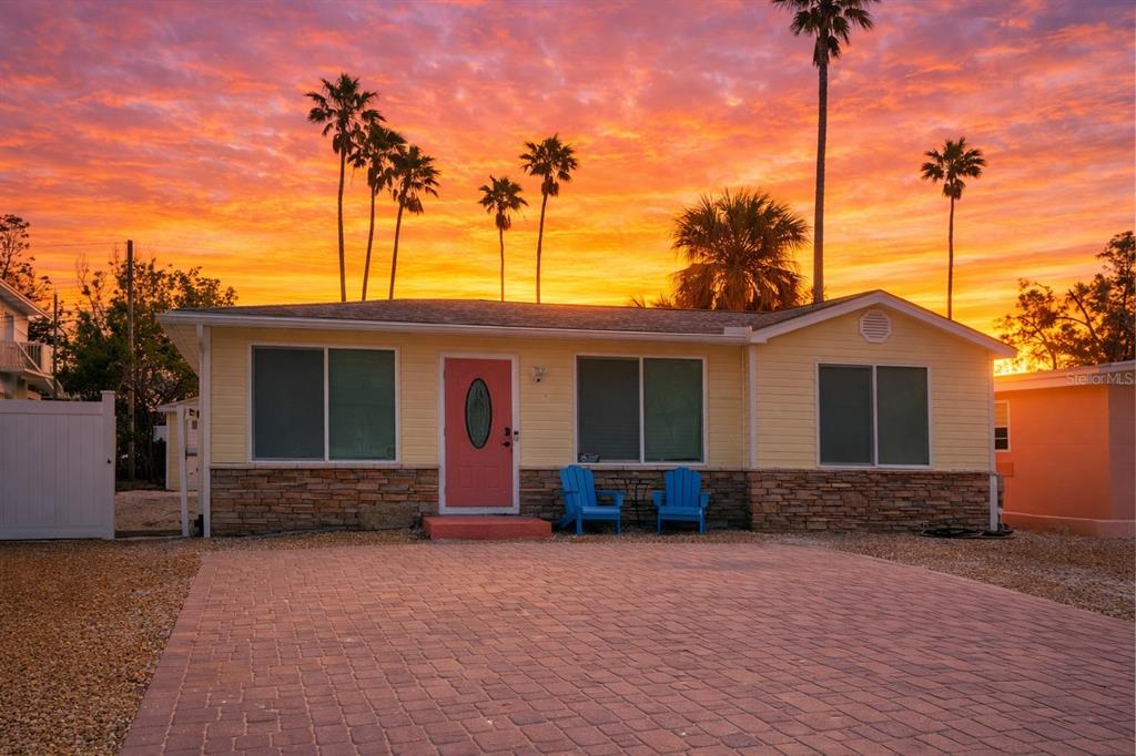 14033 Palm Street Madeira Beach, FL 33708 - Photo 1 of 41 a front view of a house with a yard