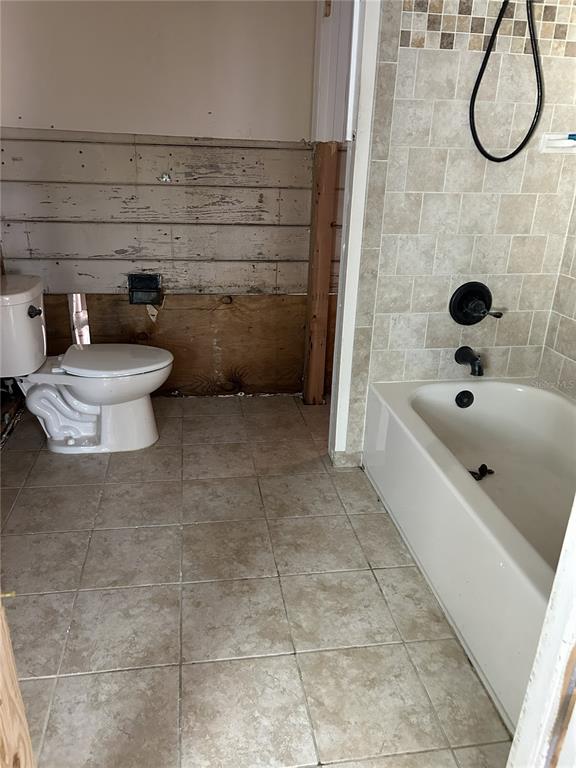 14033 Palm Street Madeira Beach, FL 33708 - Photo 17 of 41 a bathroom with a toilet and a bathtub