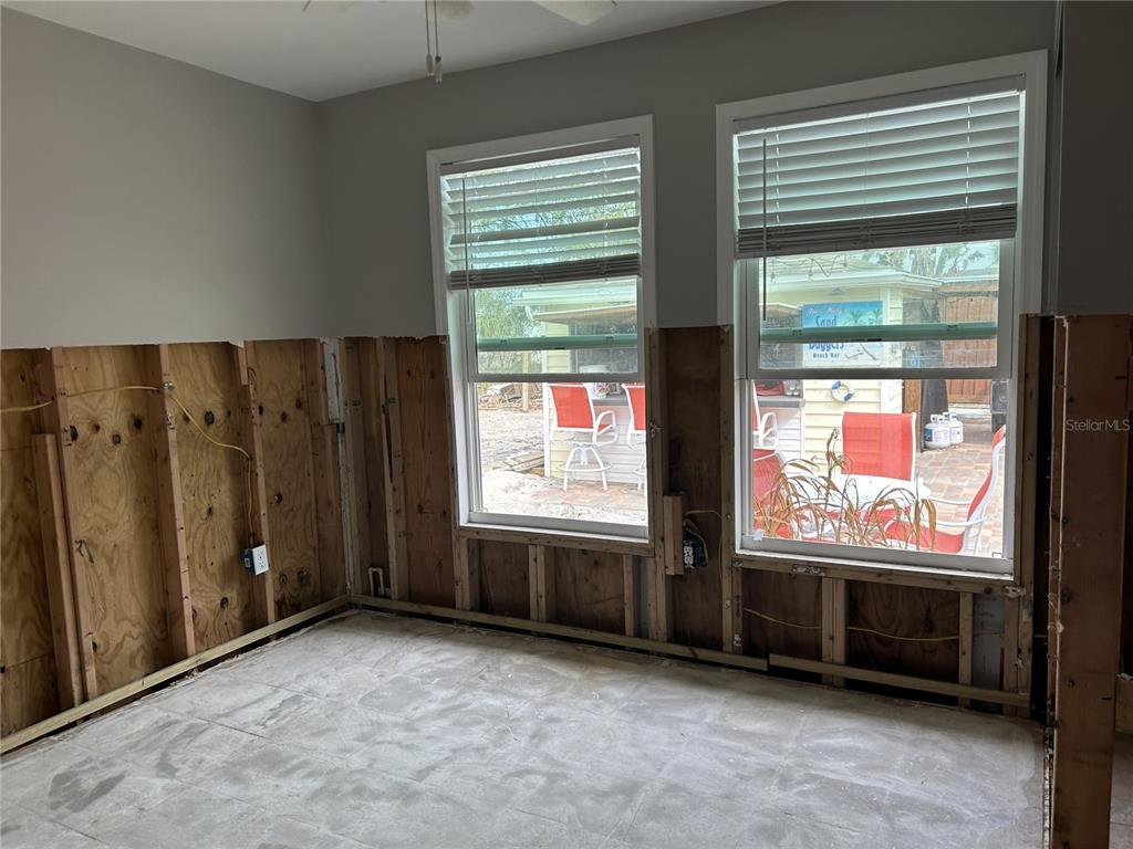 14033 Palm Street Madeira Beach, FL 33708 - Photo 19 of 41 a view of an empty room with windows