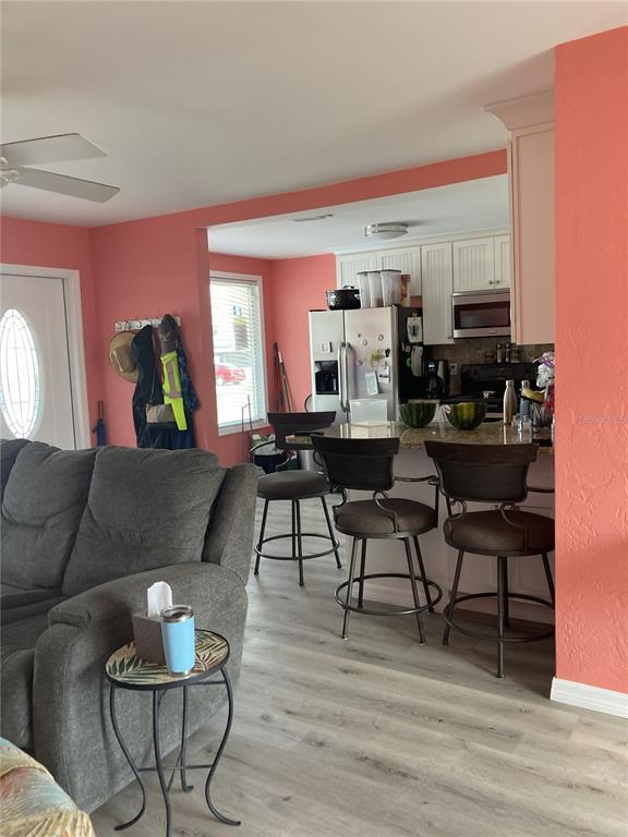 14033 Palm Street Madeira Beach, FL 33708 - Photo 22 of 41 a living room with furniture and a wooden floor