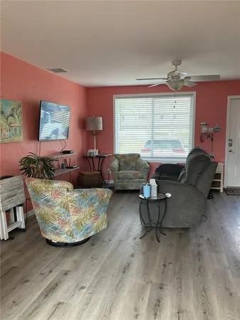 an empty room with a empty space and chandelier fan