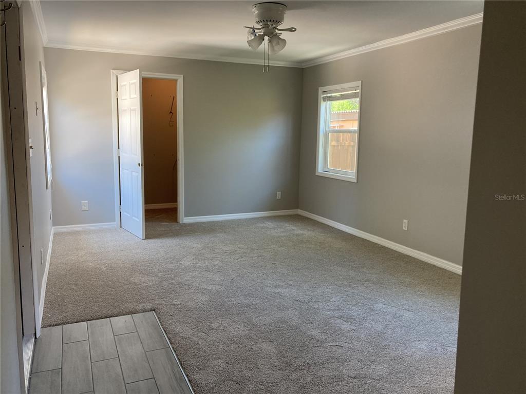 14033 Palm Street Madeira Beach, FL 33708 - Photo 27 of 41 an empty room with a empty space and chandelier fan