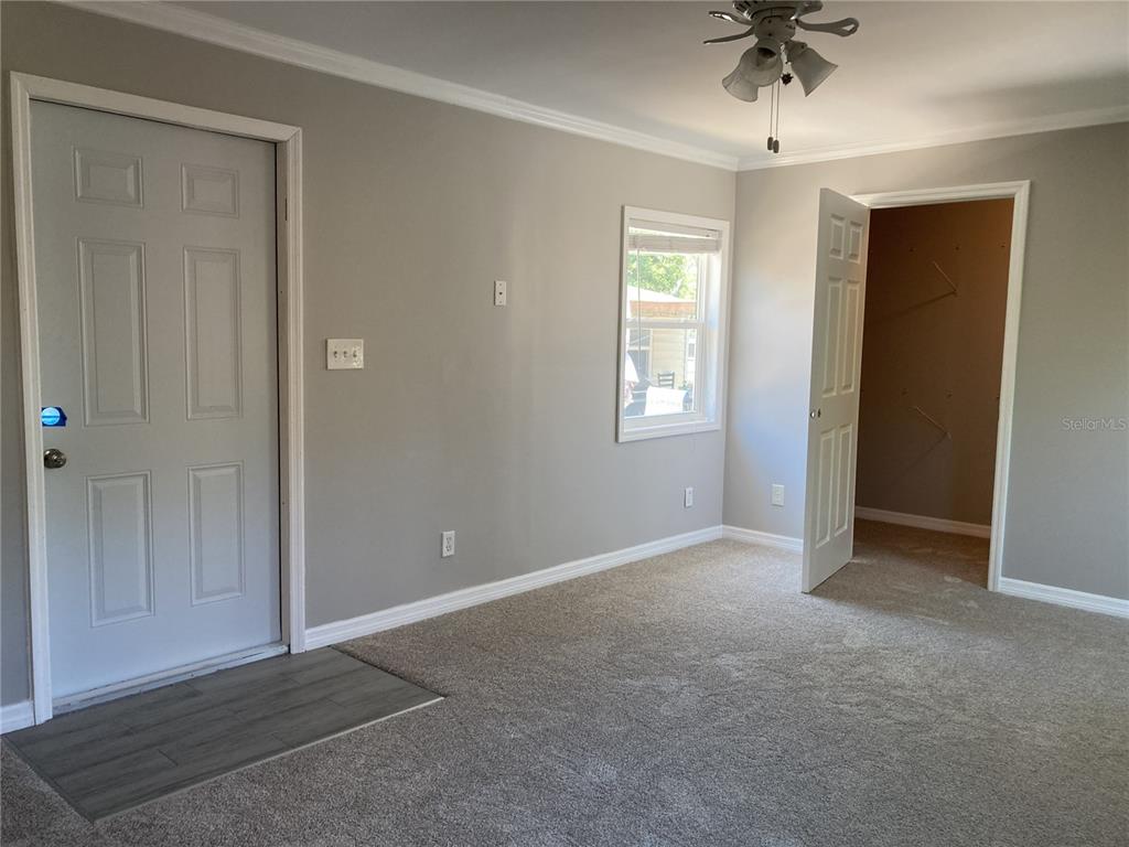 14033 Palm Street Madeira Beach, FL 33708 - Photo 28 of 41 an empty room with windows and closet area