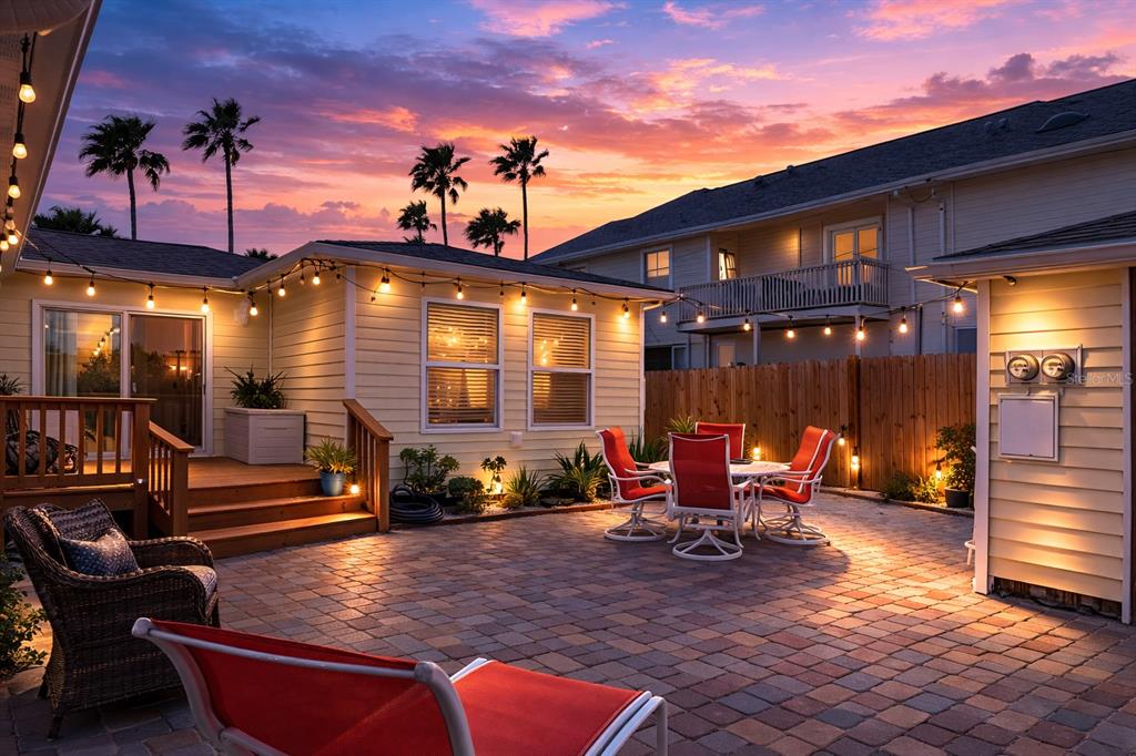 14033 Palm Street Madeira Beach, FL 33708 - Photo 34 of 41 a view of a patio with table and chairs with wooden floor