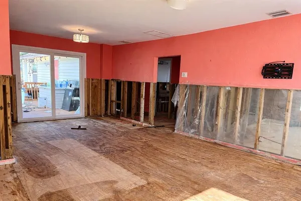 a view of a bedroom with window and a ceiling fan