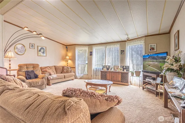 a spacious bedroom with a bed a couch and dresser