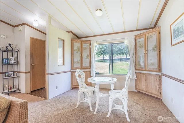a dining room with furniture and large window