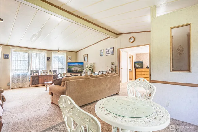 a living room with furniture a table and chairs