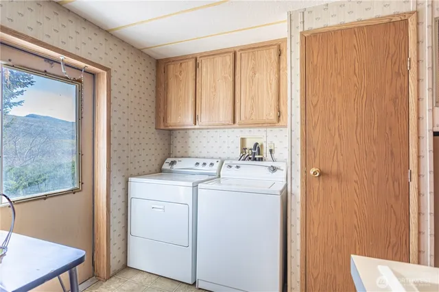 a view of storage and utility room with washer and dryer