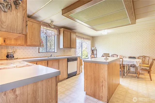 a kitchen with a cabinets and chairs