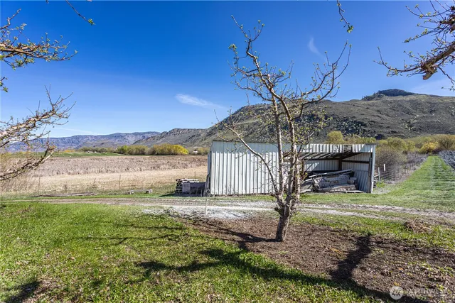 a view of a big yard with wooden fence
