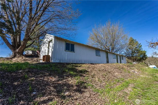 a house is sitting in middle of forest